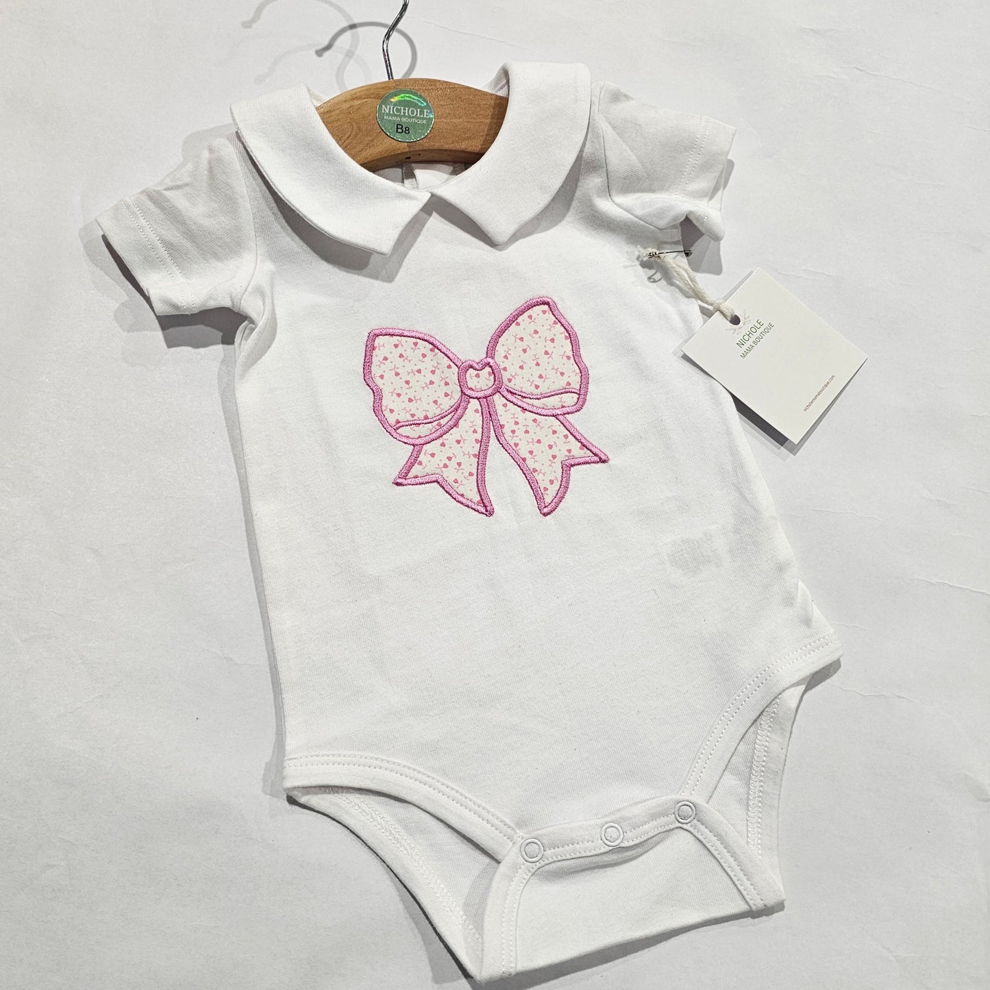 PINK BOW ONESIE